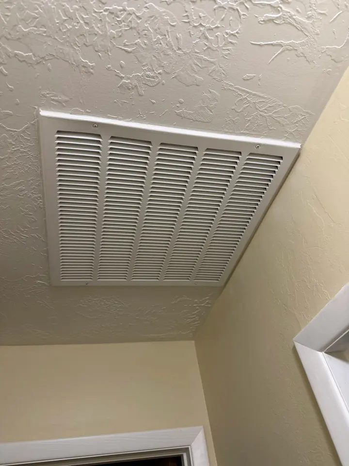 Return air grille in a hallway ceiling