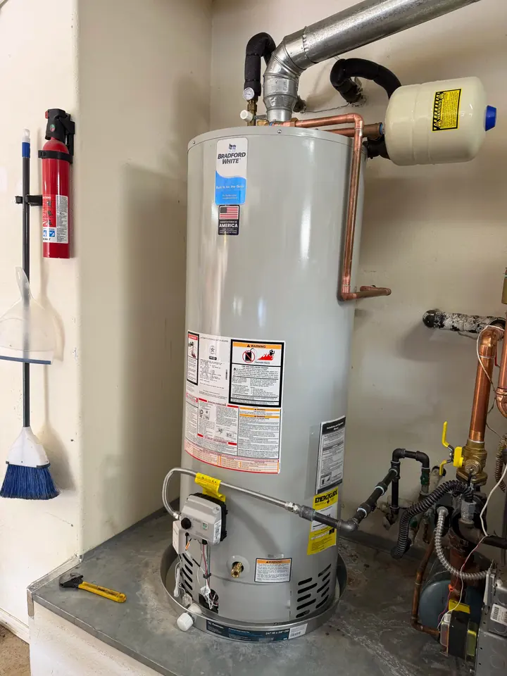 Gas water heater with new venting and copper lines in a utility closet
