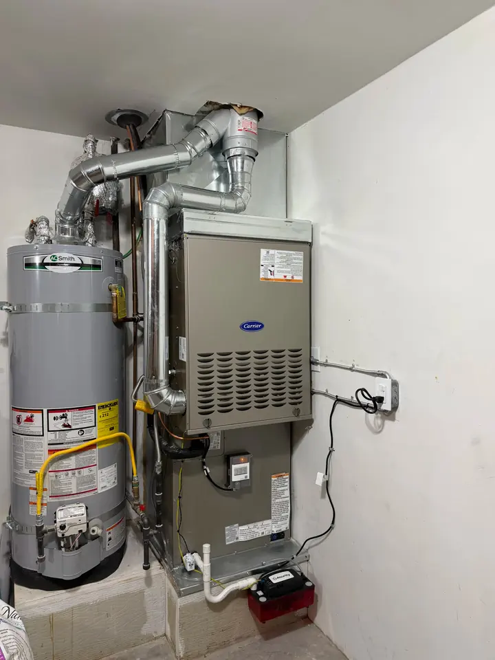 Furnace and water heater installed side by side with new venting