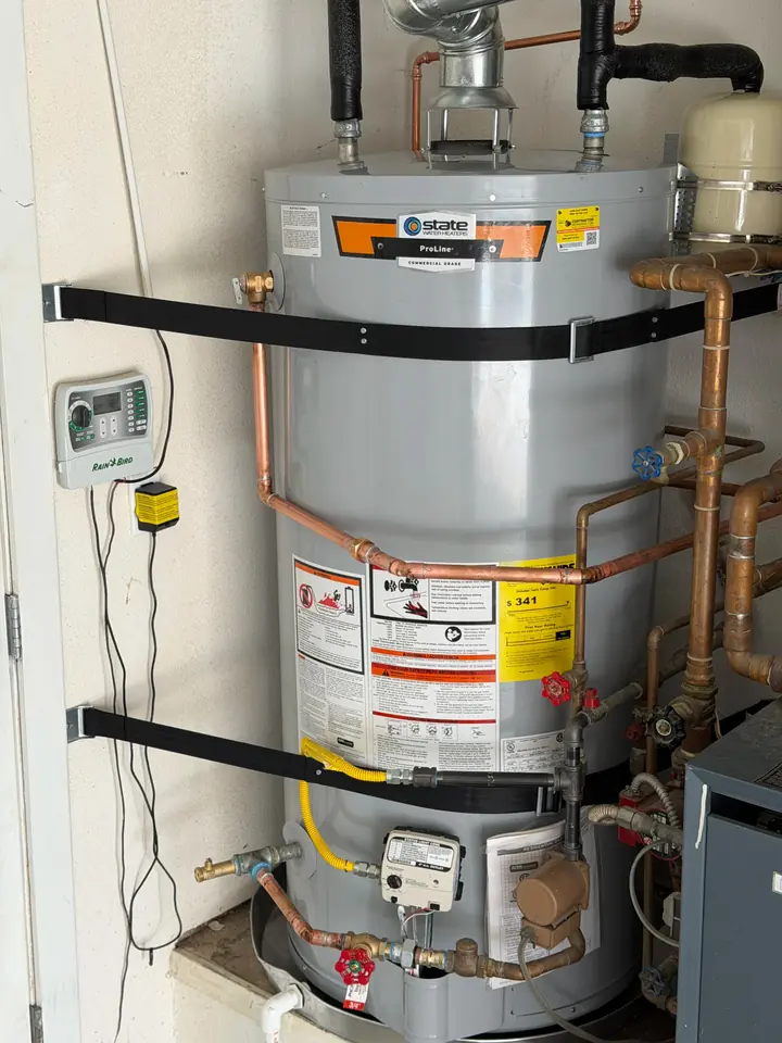 Two water heaters strapped and piped in a mechanical room