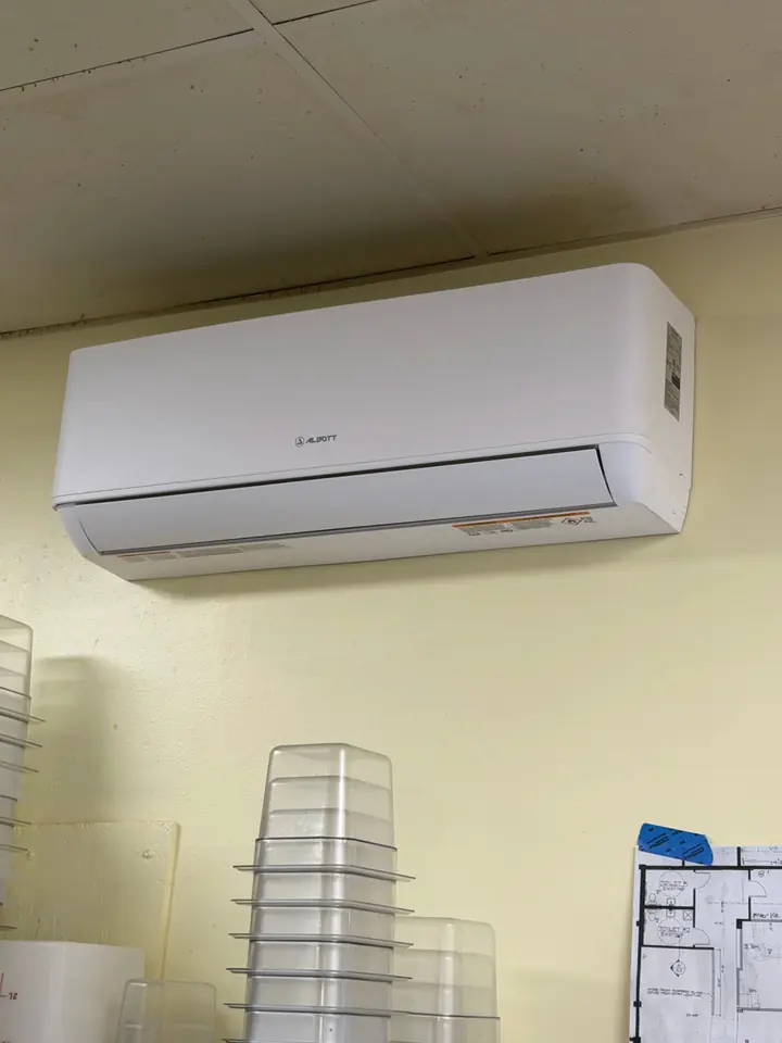 Mini split indoor head on a yellow office wall