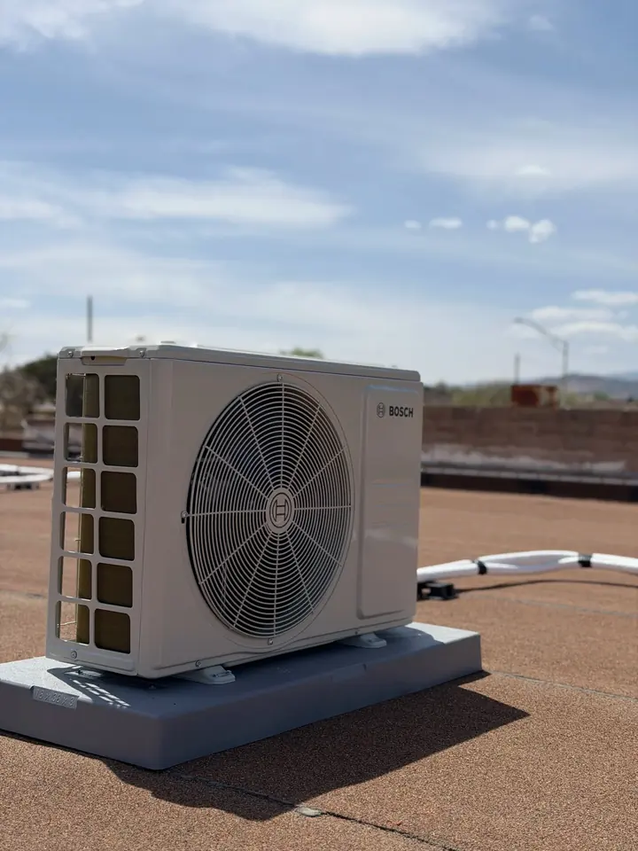 Mini split outdoor unit on a rooftop stand