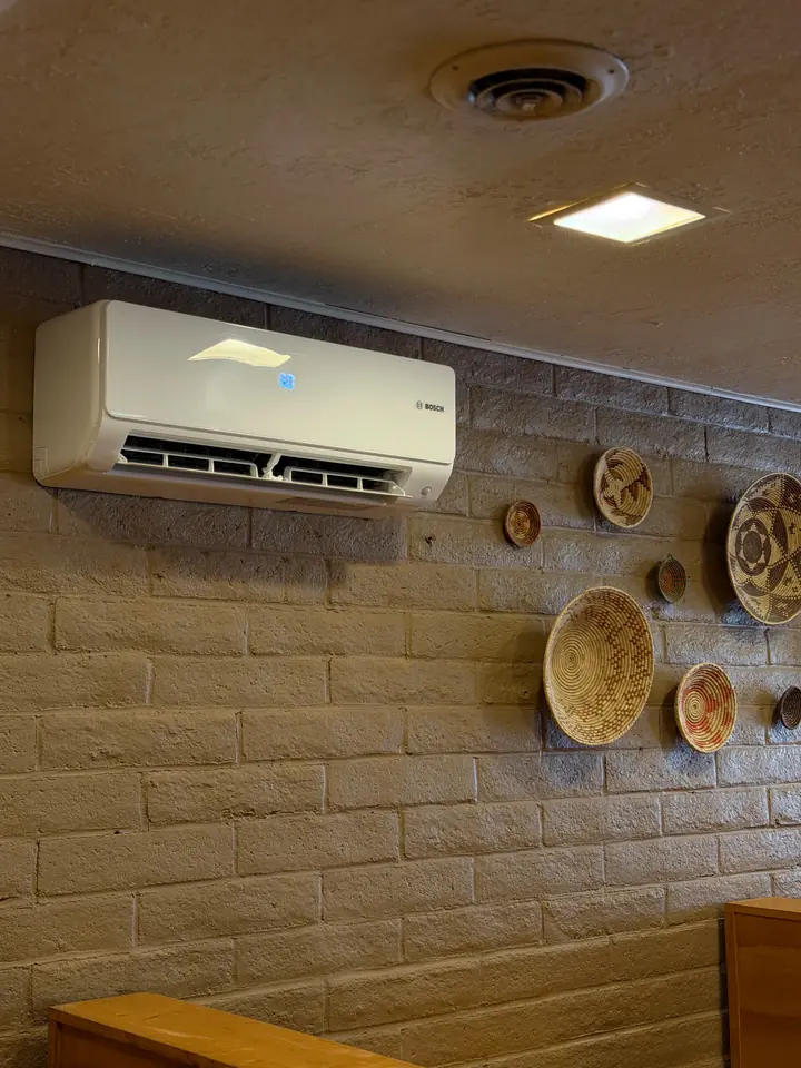 Mini split indoor head on a brick wall in a restaurant dining room