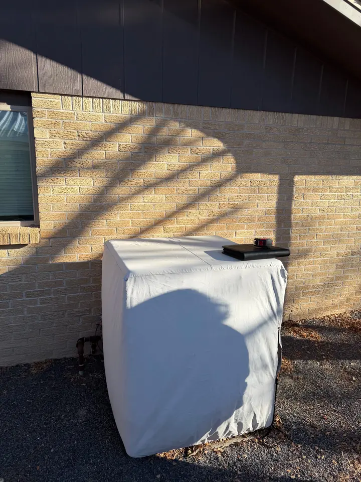 Outdoor unit under a protective winter cover